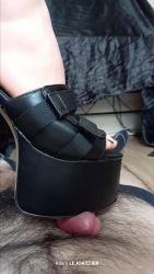 She towers over me in her gothic platform sandal.